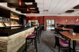 a bar in a restaurant with tables and chairs at Travelodge Hotel by Wyndham Weyburn in Weyburn
