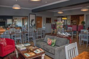 a living room with a couch and a table and chairs at Game View Lodge in Vryburg