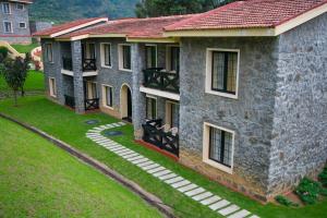 an overhead view of a stone building with a red roof at Green Pastures - A Hill Country Resort in Kodaikānāl
