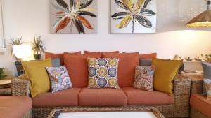 a couch with pillows on it in a living room at Bettina's wonderful flat in Riccione