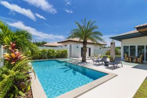 a swimming pool in the backyard of a house at Orchid Paradise Homes Villa in Hua Hin