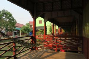 a hammock on a porch of a building at Ning Ning Bungalow in Don Det +4 photos