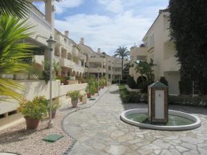 a courtyard with a fountain in front of a building at Apartment near Puerto Banus in Estepona