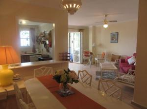 a living room with a table and a dining room at Apartment near Puerto Banus in Estepona