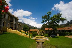 a view of a yard with a house and a bench at Green Pastures - A Hill Country Resort in Kodaikānāl