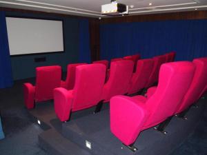 a row of pink chairs in a room with a screen at Deluxe Chevron Renaissance in Gold Coast +170 photos