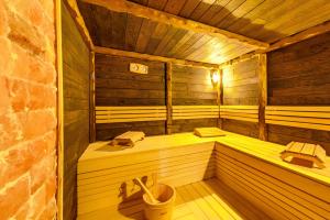 a wooden room with a sauna in a building at Hotel Leshten in Leshten