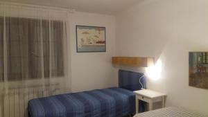 Ένα ή περισσότερα κρεβάτια σε δωμάτιο στο Appartamento Casa Elettra