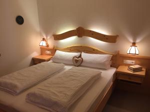twee bedden in een slaapkamer met twee lichten aan de muur bij Haus am Wiesbach in Reit im Winkl
