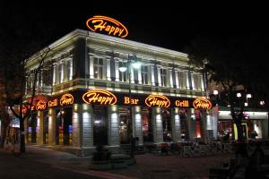 a building with a sign on top of it at night at Apartment Pier in Varna City