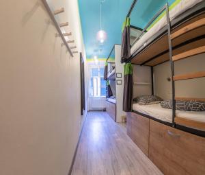 a room with two bunk beds and a hallway at The RoadHouse Prague in Prague