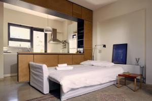 a bedroom with a large white bed in a room at Two level apartment with panoramic view in Athens