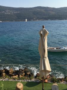 a statue of a man standing next to a body of water at Roditses Beach Sea Front Apartments in Samos