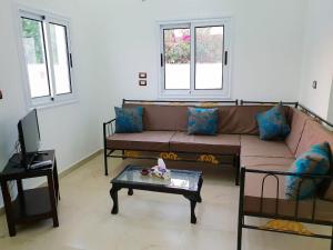 a living room with a couch and a table at Marhaba Guest House in Luxor