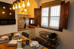 a kitchen with a table and a dining room at Meraki Suites Albaycin in Granada