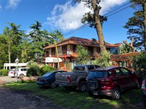 zwei Autos, die vor einem Haus geparkt sind in der Unterkunft Hotel Villa Santa Maiani in Mar del Plata