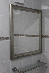 a mirror on a wall in a bathroom at App mit Klima, Pool, Garage für Auto, Bike, Skier, AktivCARD optional in Sankt Englmar
