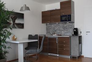 a kitchen with a desk and a table and chairs at Appartement in Sankt Englmar mit KlimaWärmetauscher in Sankt Englmar