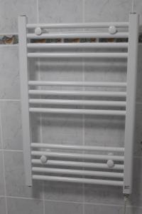 a white metal radiator on a wall in a room at App mit Klima, Pool, Garage für Auto, Bike, Skier, AktivCARD optional in Sankt Englmar +31 photos