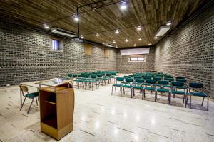 a lecture hall with green chairs and a podium at Ajloun Forest Reserve in Ajloun