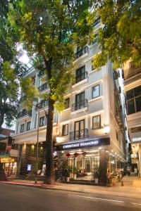 a large white building on the side of a street at Hanoi L'Heritage Diamond Hotel & Spa in Hanoi