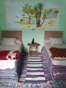 Postel nebo postele na pokoji v ubytování Aswan Nubian House