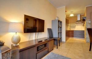 a living room with a flat screen tv on the wall at Apartament Czekoladowy in Karpacz