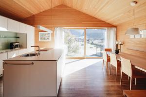 a kitchen with a sink and a table with chairs at Ferienhaus Wenefrieda in Schoppernau