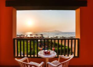 a table on a balcony with a view of the ocean at Charmillion Sea Life Resort in Sharm El Sheikh