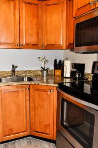 a kitchen with wooden cabinets and a sink at Blue Waters Treasure Island in St Pete Beach