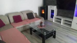 a living room with a couch and a coffee table at APARTMAN SAUNA "NINO" in Gornje Jesenje