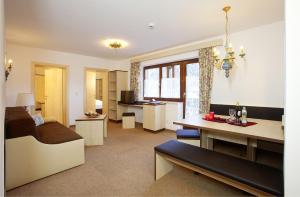 a living room with a bed and a dining room at Appartement Alpin in Sölden