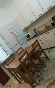 a kitchen with a table and chairs and a microwave at Your Home in Genova in Genoa