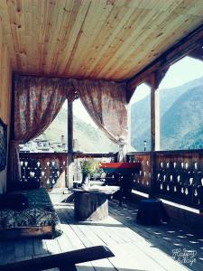 a screened in porch with a table and a piano at Makratela in Akhmety