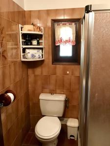 a small bathroom with a toilet and a window at Chambre d'Hôtes Casa Mia in Belvédère