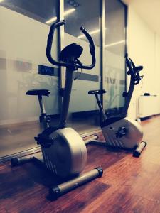 a gym with two exercise bikes on the floor at Nymfes Hotel in Kato Loutraki