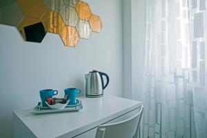 a table with cups and a tea pot on it at B&B Sapore di Mare al Corso in Gaeta