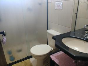 a bathroom with a toilet and a sink at Apartamentos Di Armazzem in Torres +29 photos