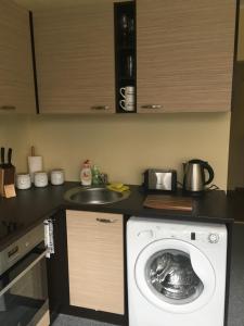 a kitchen with a washing machine and a sink at Liivalaia Apartment in Tallinn
