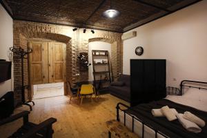 a room with a bed and a table and a chair at Chrono Room in Tbilisi City