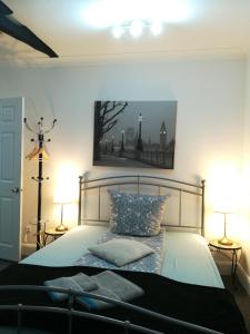 a bedroom with a large bed with two lamps at Royal Guest House II in Viersen