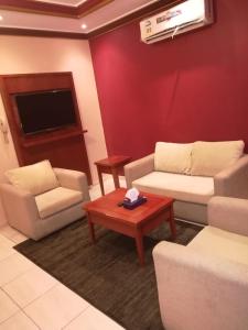 a living room with two couches and a table at لين للشقق المخدومة in Jeddah
