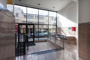 a hallway with a door to a building with a car at Lace Market Apartments - Nottingham City Centre most Central Location in Thurland Street - minutes to Motorpoint Arena and Victoria Centre Shopping Centre in Nottingham