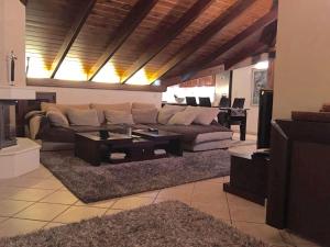 a living room with a couch and a table at The Loft in Chios