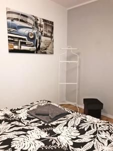 a bedroom with a bed and a picture of a car at Powstańców Wielkopolskich 12 in Poznań