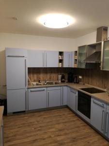 a kitchen with white cabinets and a sink at Ferienwohnung in der Rhön Sitzmann in Bischofsheim an der Rhön