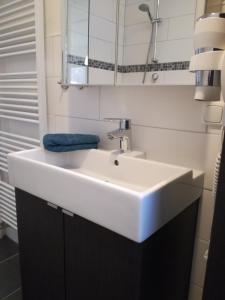 a bathroom with a white sink and a mirror at Ferienwohnung in der Rhön Sitzmann in Bischofsheim an der Rhön
