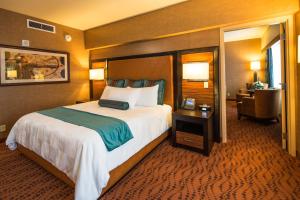 a hotel room with a large bed and a desk at Akwesasne Mohawk Casino Resort and Players Inn Hotel -formerly Comfort Inn and Suites Hogansburg NY in Hogansburg