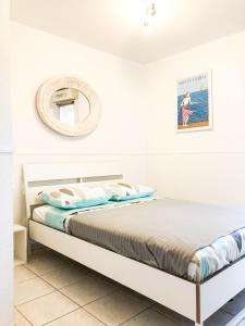 a white bedroom with a bed in a room at Portobello residence in Nice