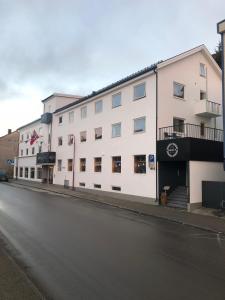 un bâtiment blanc sur le côté d'une rue dans l'établissement Arctic Hotel Nordkapp, à Honningsvåg